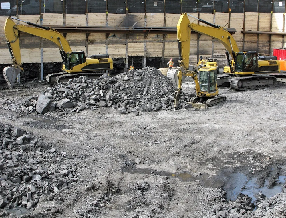 Excavators clearing rubble on a commercial demolition site