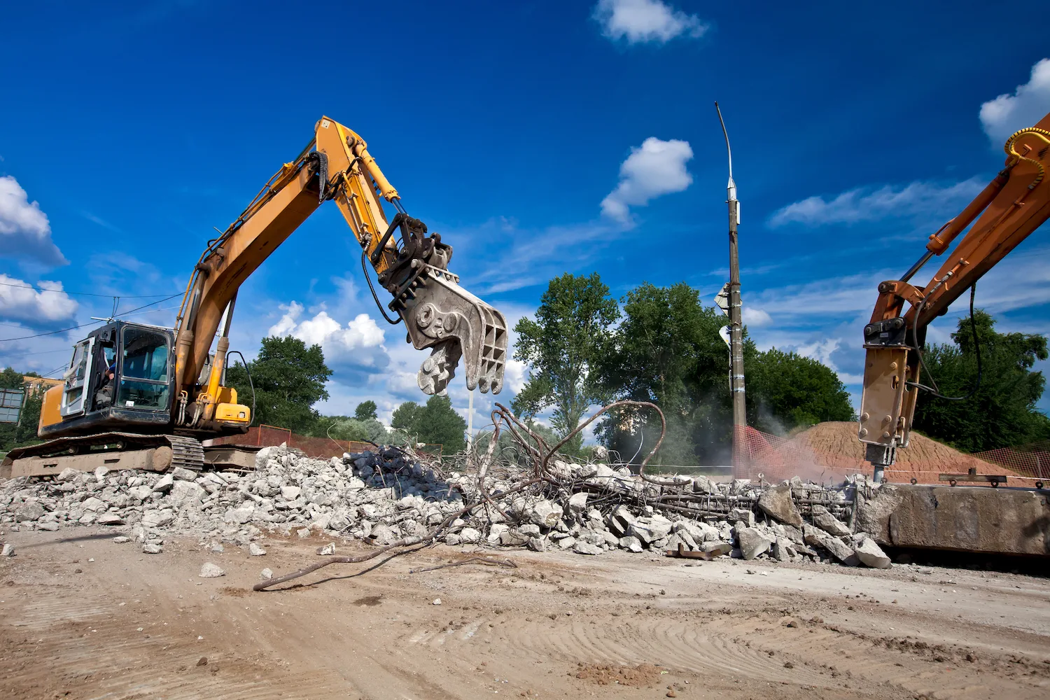 Excavator with grapple demolishing a building in Perth