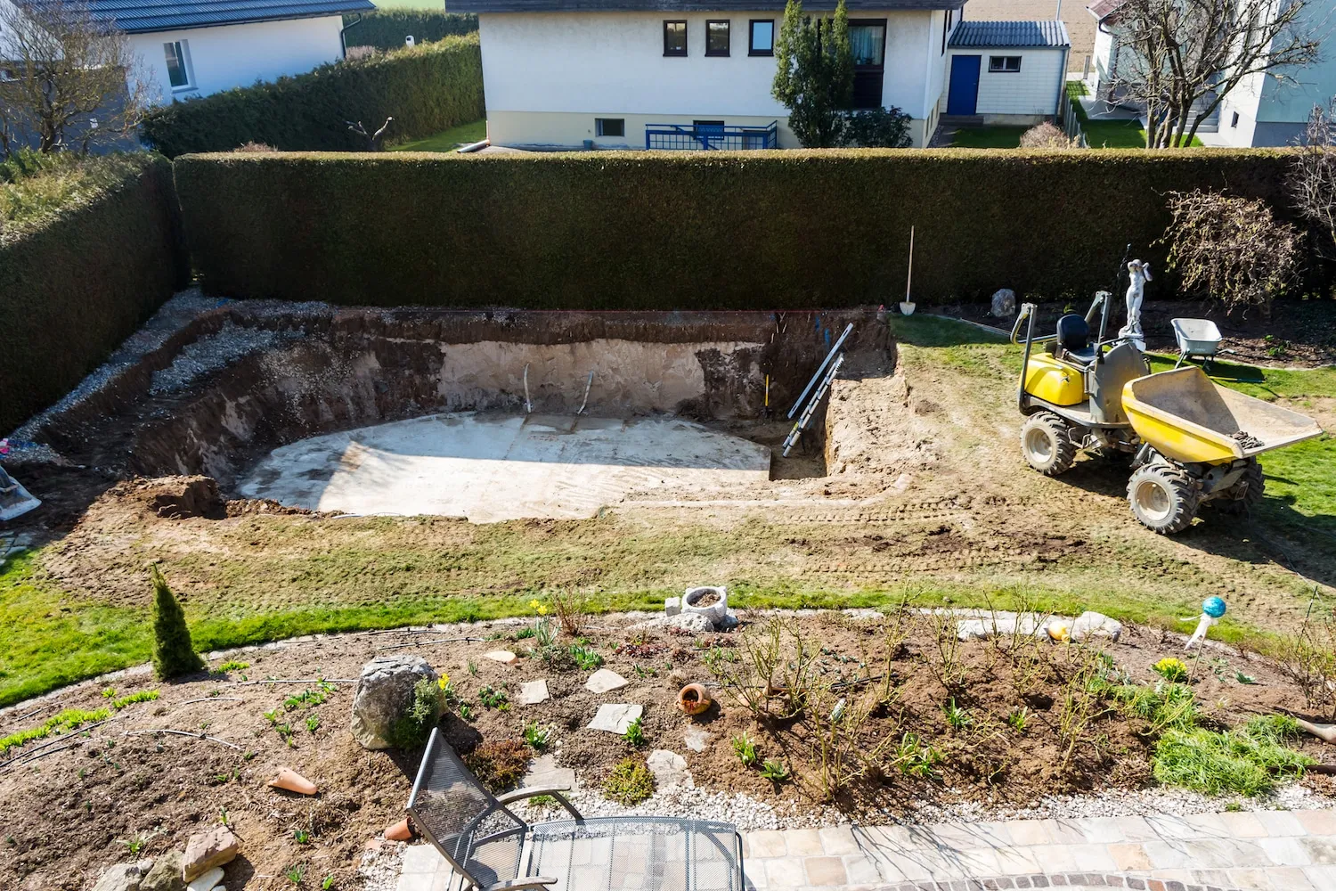 Backyard in-ground swimming pool being removed and filled