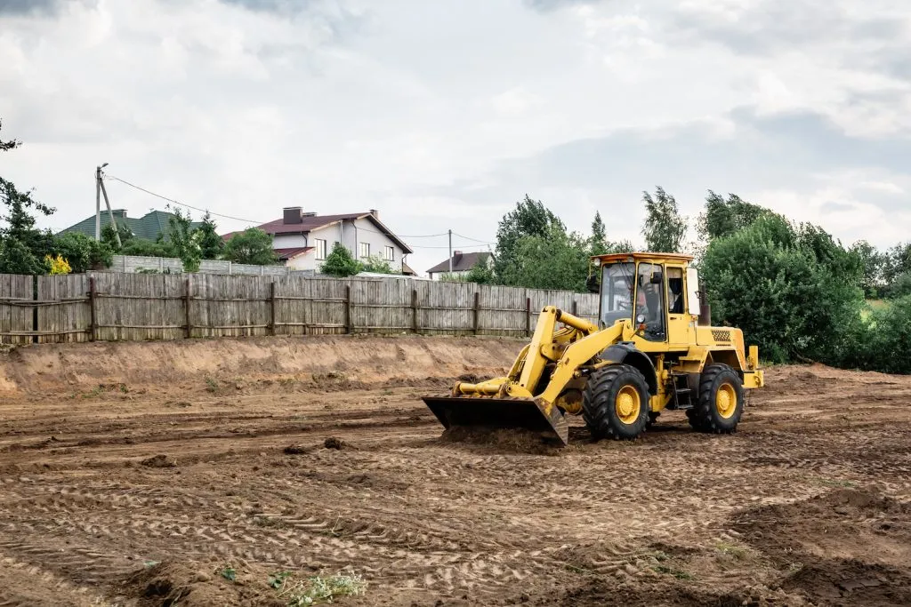 Wheel loader levelling a cleared residential block