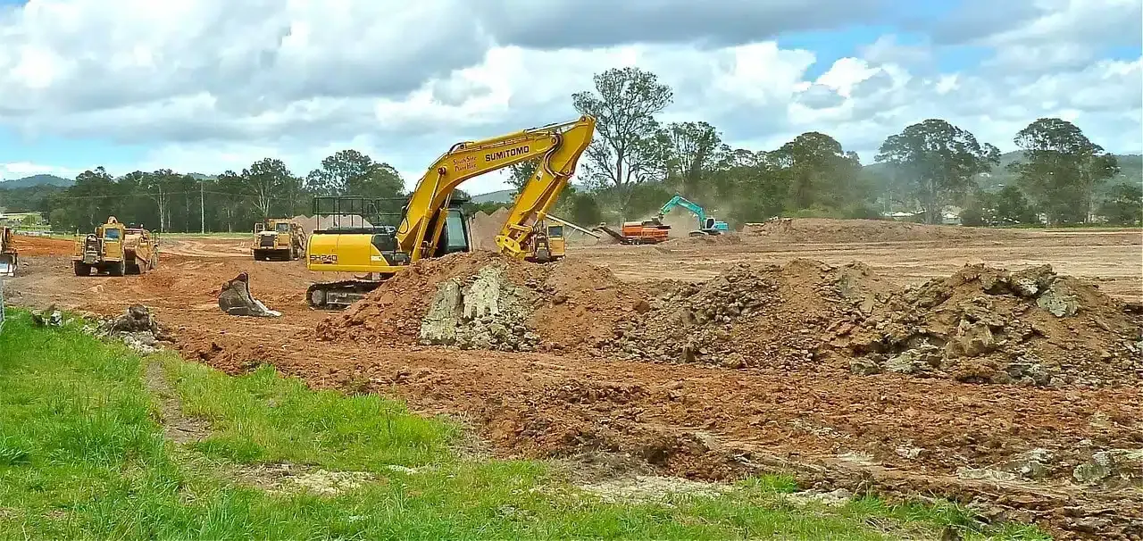 Excavators clearing and levelling a large block of land